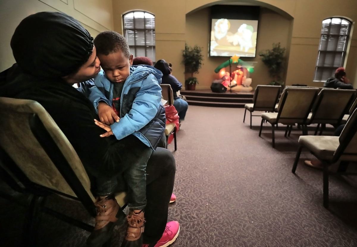 <strong>Jameshua Clark and her son Logan Williams, 2, wait to shop for stocking-stuffers during the Neighborhood Christian Center's annual Christmas toy store on Thursday, Dec. 20.</strong> (Jim Weber/Daily Memphian)