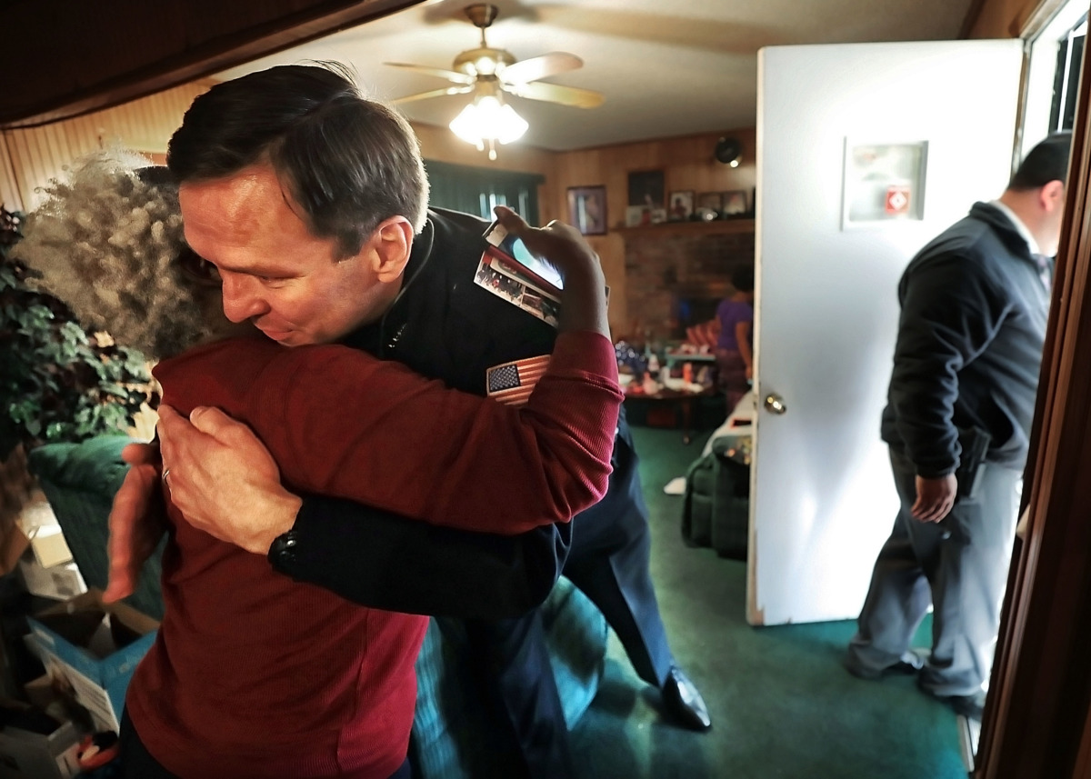 <strong>Burglary victim Patricia Byers embraces Memphis Police Deputy Chief Michael Shearin as she thanks Memphis Police officers and Boll Weevils who showed up at her home on Wednesday, Dec. 19, with Christmas gifts to replace presents that were stolen from her home.</strong> (Jim Weber/Daily Memphian)