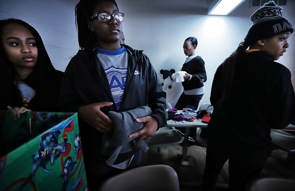 <strong>Sheniqua Woodard (from left), Christina Elliott and Briauna Stewart sort through winter clothing items collected during the coat drive held by the Memphis Ambassadors Program. MAP collected more than 1,200 clothing items to distribute to needy kids.</strong> (Jim Weber/Daily Memphian)