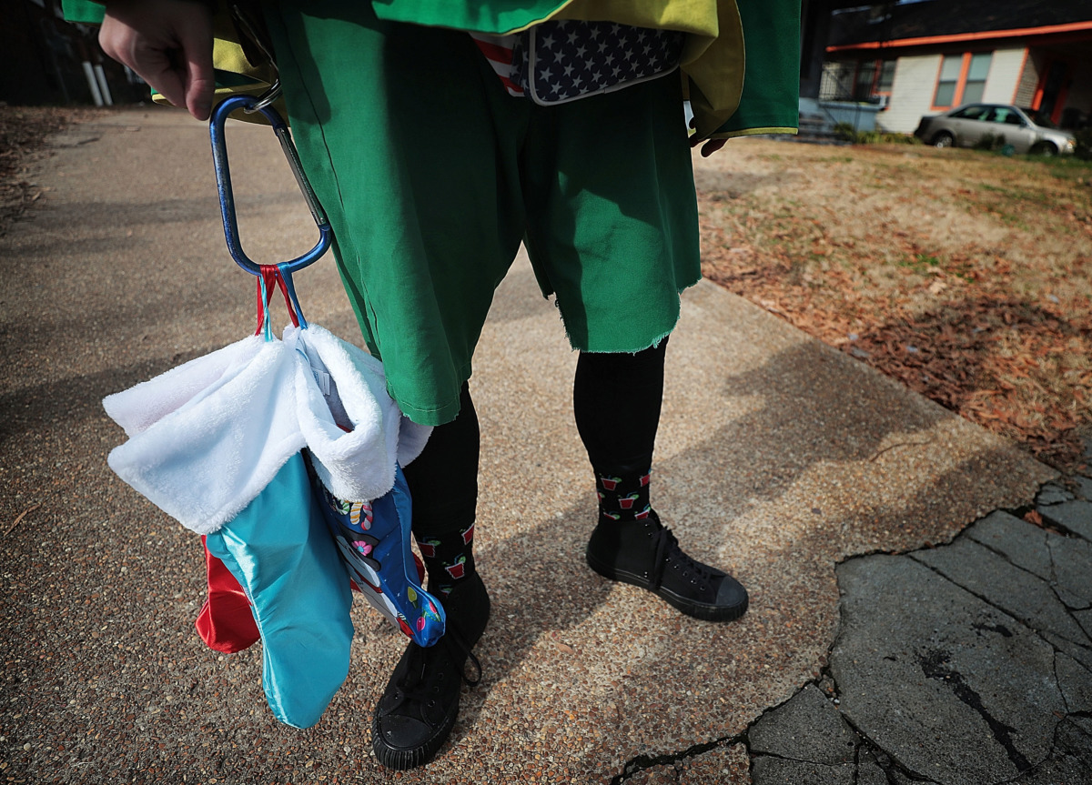<strong>One of the Memphis Boll Weevils delivers Christmas presents to victims of recent burglaries.</strong> (Jim Weber/Daily Memphian)