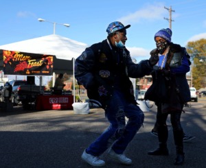<strong>Larry Werby and Lena Lewis dance after getting a Thanksgiving meal at Mississippi Boulevard Christian Church on Thursday, Nov. 26. Due to the coronavirus pandemic, this year&rsquo;s MemFeast was set up at six church parking lots across the city, and meals were distributed in to-go containers.</strong> (Patrick Lantrip/Daily Memphian)