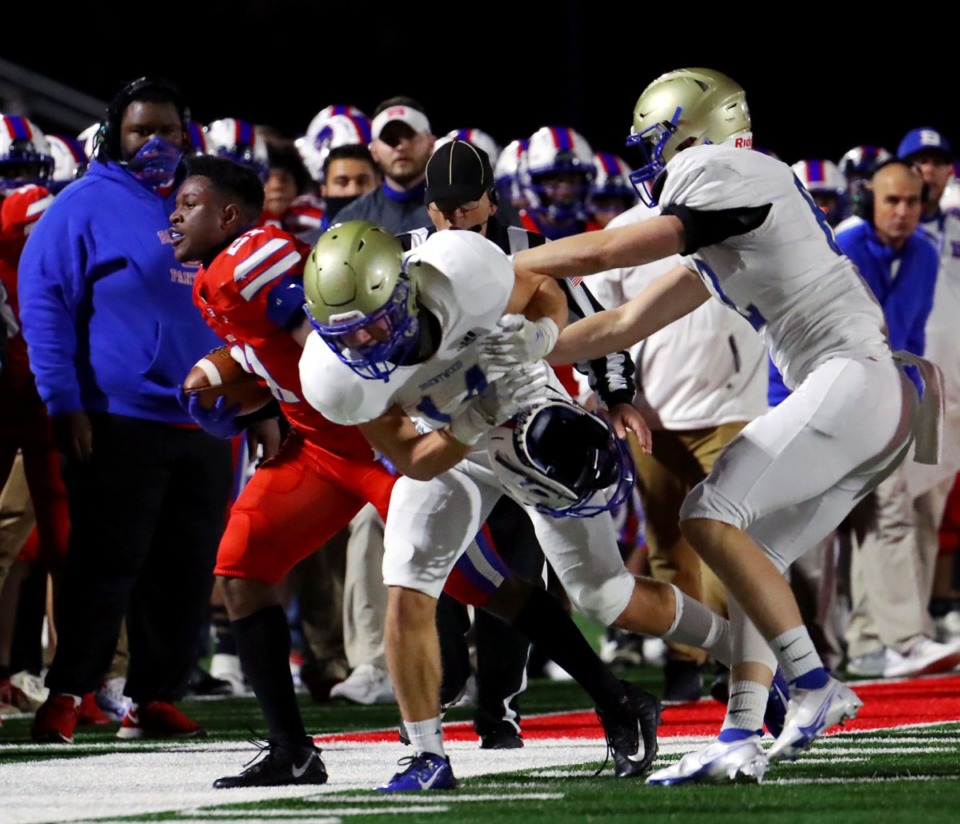 <strong>Bartlett High School running back Robert Giaimo (21) gets his helmet ripped off by Brentwood High School cornerback Carter Patton (14) during a Nov. 27 game at Bartlett High School.</strong> (Patrick Lantrip/Daily Memphian)