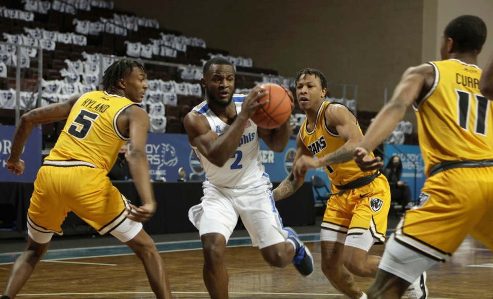 <strong>Alex Lomax (2) of the Memphis Tigers drives into Virginia Commonwealth defenders during the Bad Boy Mowers Crossover Classic Friday, Nov. 27 at the Sanford Pentagon in Sioux Falls, S.D.</strong> (Richard Carlson/Inertia)