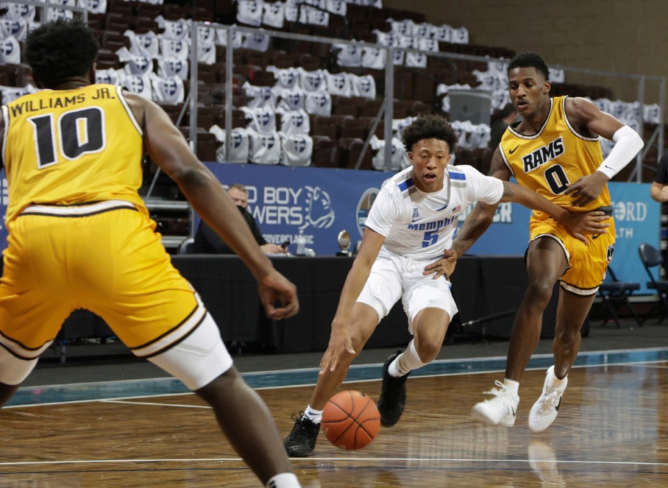 <strong>Boogie Ellis (5) of the Memphis Tigers drives past Jamir Watkins (0) of the Virginia Commonwealth Rams during the Bad Boy Mowers Crossover Classic Friday, Nov. 27 at the Sanford Pentagon in Sioux Falls, S.D.</strong> (Richard Carlson/Inertia)