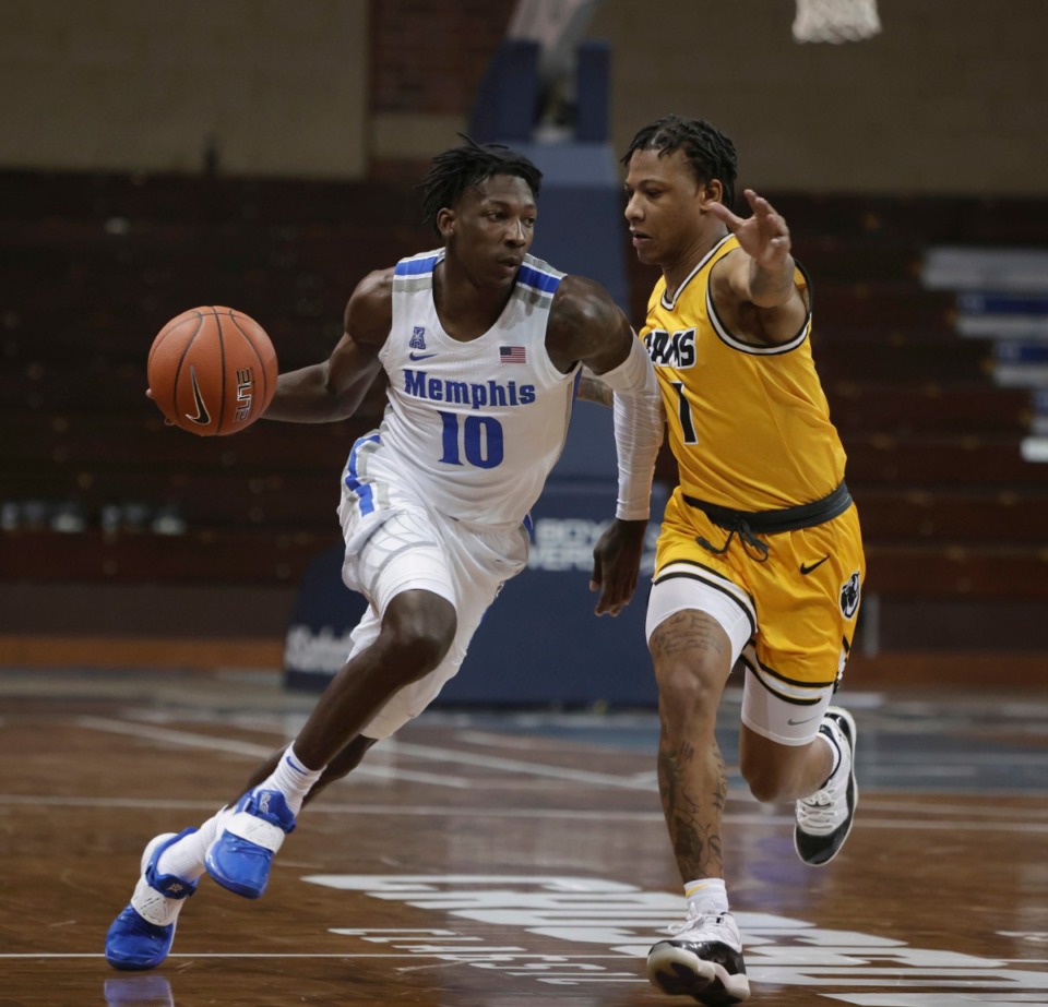 <strong>Damion Baugh (10) of the Memphis Tigers drives at Adrian Baldwin Jr. (1) of the Virginia Commonwealth Rams during the Bad Boy Mowers Crossover Classic Friday, Nov. 27 at the Sanford Pentagon in Sioux Falls, S.D.</strong> (Richard Carlson/Inertia)