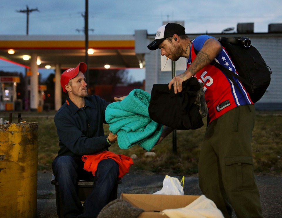 <strong>Justin Warriner (left) helps his friend Jeffery McConnico fold a blanket during a needle exchange event held Friday, Nov. 27, by A Betor Way. In addition to Narcan and needle exchanges, A Betor Way also provides food and clothing to Memphians struggling with addiction.</strong> (Patrick Lantrip/Daily Memphian)