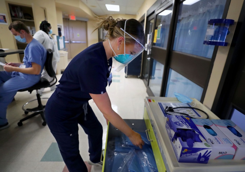 <strong>Registered nurse Ali Durbin gears up to go inside a COVID-positive patient room at Regional One in September</strong>. (Patrick Lantrip/Daily Memphian file)