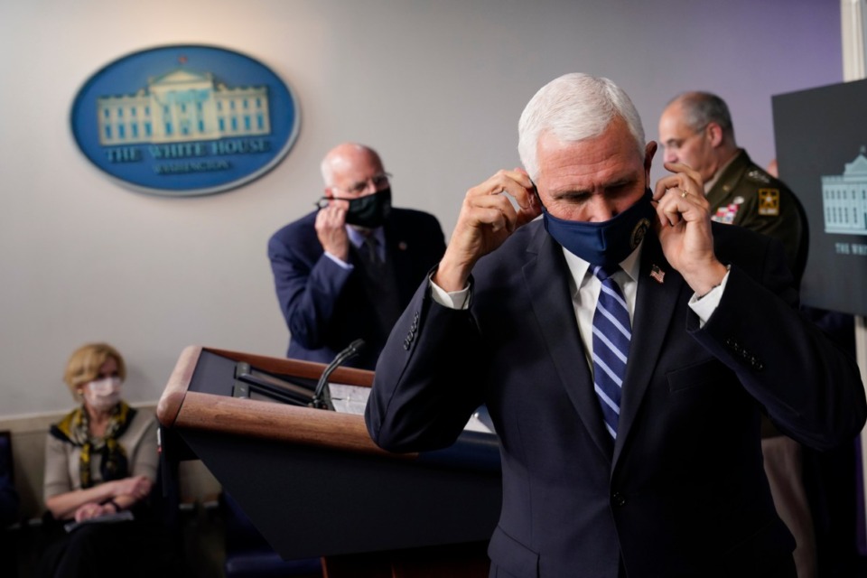 <strong>Vice President Mike Pence adjusts his face mask during a news conference with the coronavirus task force at the White House in Washington, Thursday, Nov. 19, 2020.</strong> (Susan Walsh/AP)