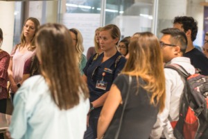 <strong>Students listen closely to Dr. Scott Morris during a (pre-pandemic) tour of Church Health at Crosstown Concourse. Students may be tapped to help fill the growing staffing needs of hospitals and vaccine distribution in the coming weeks.</strong> (Daily Memphian file)