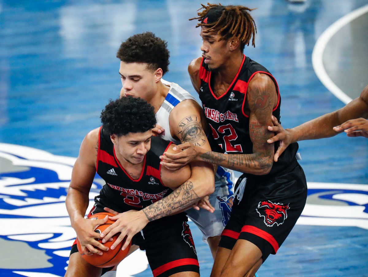 <strong>Lester Quinones (middle) applies pressure to Arkansas State guard Marquis Eaton (left) as Keyon Wesley (right) helps on the play on Dec. 2, 2020.</strong> (Mark Weber/The Daily Memphian)