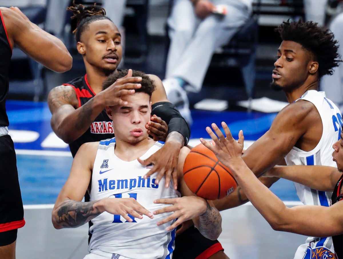 <strong>Memphis guard Lester Quinones (bottom) battles Arkansas State defender Markise Davis (top) for a rebound as teammate Ahmad Rand (right) helps on the play.</strong> (Mark Weber/The Daily Memphian)