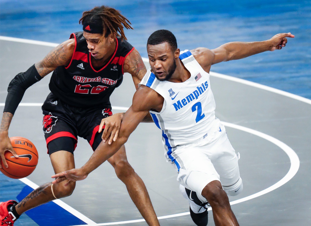 <strong>Alex Lomax (right) goes for a steal against Arkansas State forward Keyon Wesley (left).</strong> (Mark Weber/The Daily Memphian)