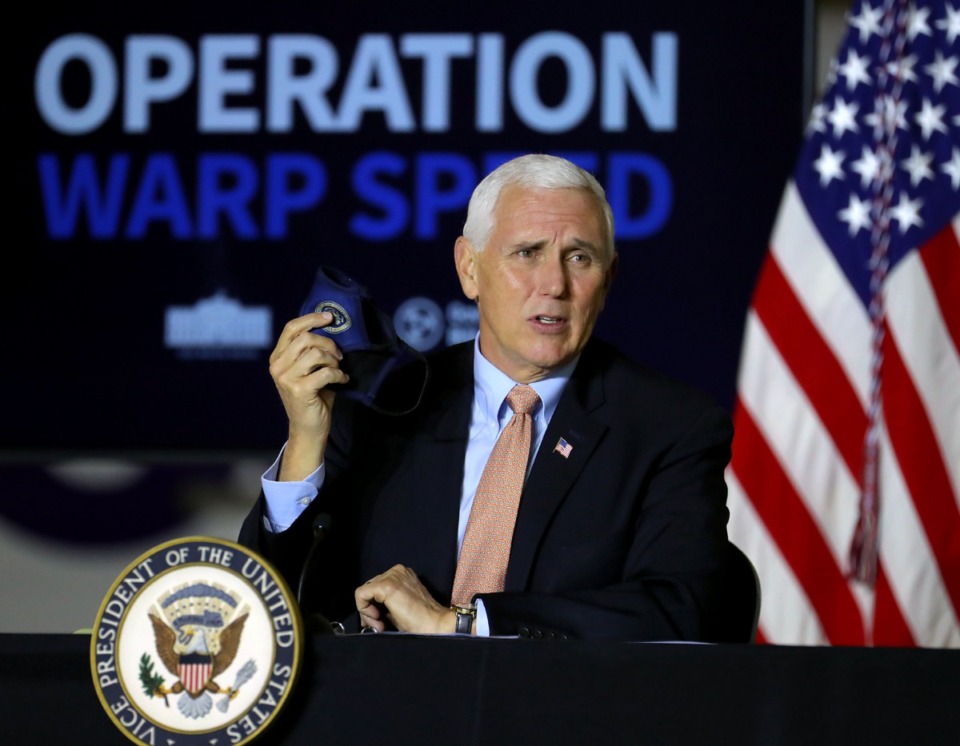 <strong>Vice President Mike Pence holds up a mask while giving an update on Operation Warp Speed during a visit to Memphis on Thursday, Dec. 3.</strong> (Patrick Lantrip/Daily Memphian)