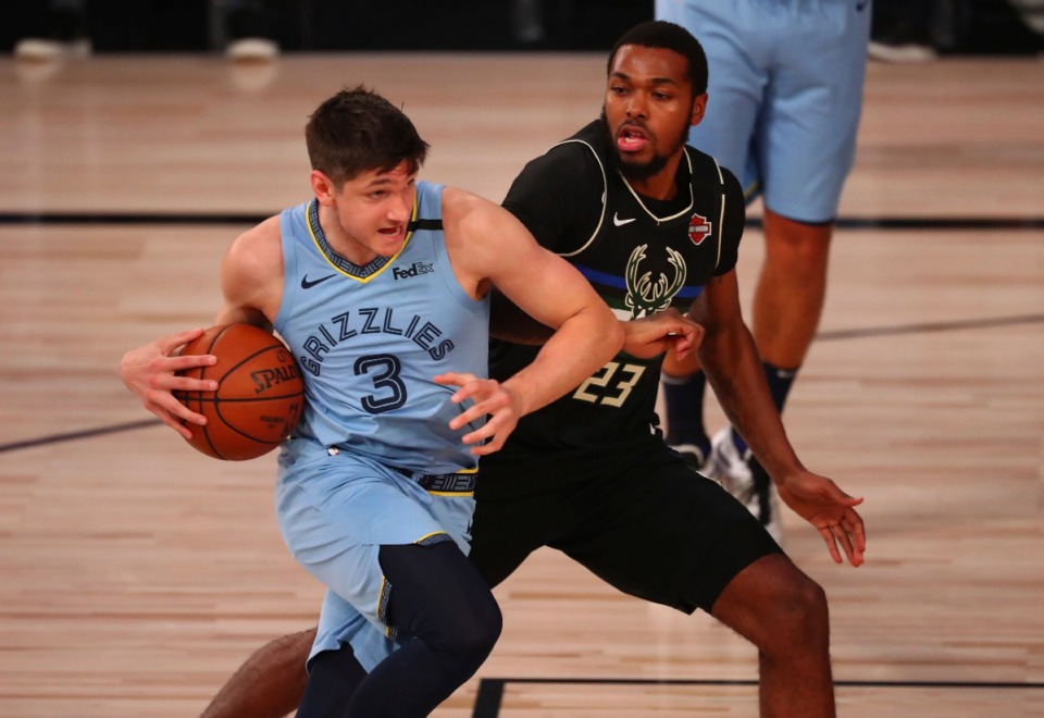 <strong>Memphis Grizzlies guard Grayson Allen (3) drives against Milwaukee Bucks guard Sterling Brown (23) in the first half of an NBA basketball game Thursday, Aug. 13, 2020, in Lake Buena Vista, Fla.</strong> (Kim Klement/AP)