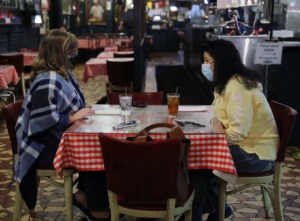 <strong>Denise Tate (left) and Ramona Snow wear masks while waiting for their food at Rendezvous on Dec. 1, 2020.</strong> (Patrick Lantrip/Daily Memphian)