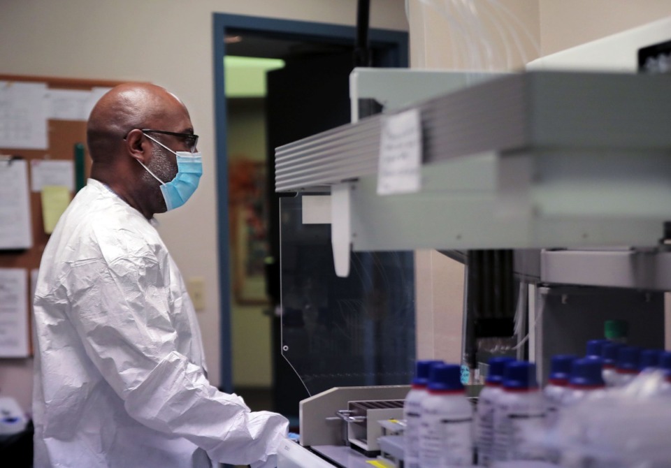 <strong>Paul McQueen tests samples for coronavirus at a University of Tennessee Health Science Center lab in September.</strong> (Patrick Lantrip/Daily Memphian file)