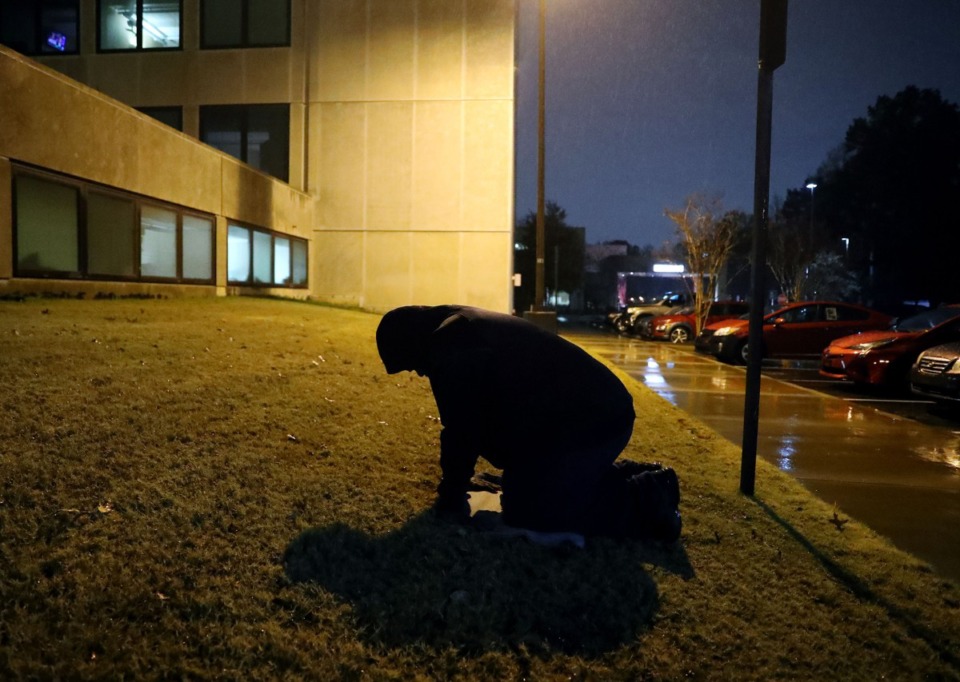 <strong>Darrell Cobbins prays outside the Baptist Memorial Hospital emergency room after his brother, Donnell, died from COVID-19 complications Dec. 11, 2020. Cobbins prayed outside the hospital every night since his brother was admitted a week earlier.</strong> (Patrick Lantrip/Daily Memphian)
