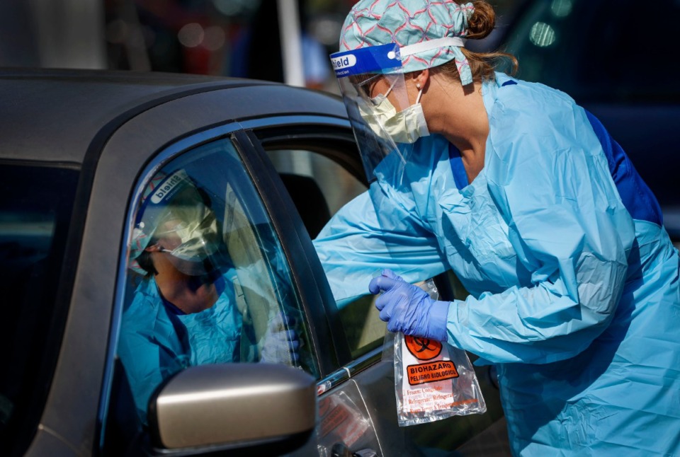 <strong>A nurse administers COVID-19 swabs during a drive-thru testing site at Baptist Memorial Hospital-Memphis.</strong> (Mark Weber/Daily Memphian file)