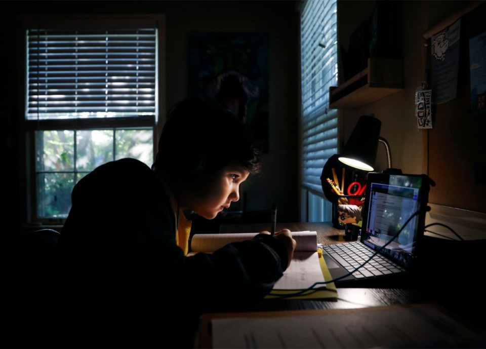<strong>Snowden School third grader Cooper Tate writes down sentences during virtual learning.</strong> (Mark Weber/The Daily Memphian file)