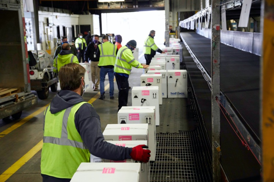 <strong>Workers at the FedEx Express world hub in Memphis handle packages of COVID-19 vaccine during sorting on Sunday, Dec. 13.</strong> (Courtesy FedEx)