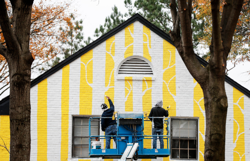 <strong>Painters paint abstract murals of trees on the Williamsburg Manor apartments on Tuesday, Dec. 15, 2020. Sunny day shadows cast onto the murals by the real oaks create a kind of dynamic, organic art. </strong>(Mark Weber/The Daily Memphian)