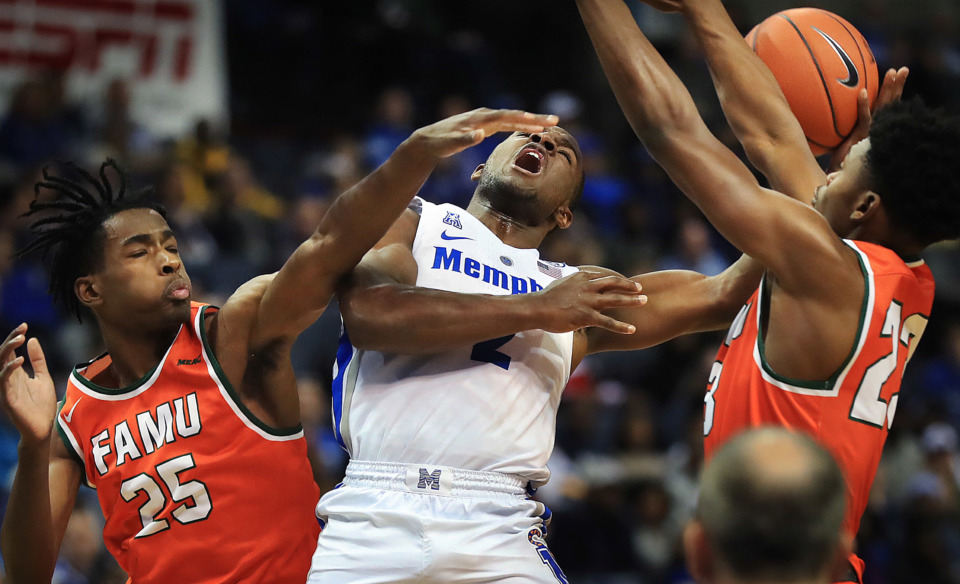 <strong>University of Memphis guard Alex Lomax (2) shoots under pressure by Florida A&amp;M's D.J. Jones during the Tigers game against the Rattlers at the FedExForum on Dec. 29, 2018.</strong> (Jim Weber/Daily Memphian)