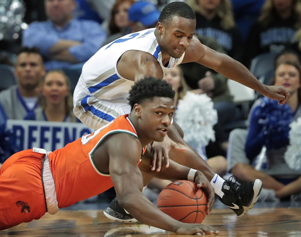 <strong>University of Memphis guard Alex Lomax (2) scrambles for a loose ball with Florida A&amp;M's Nasir Core during the Tigers game against the Rattlers at the FedExForum on Dec. 29, 2018.</strong> (Jim Weber/Daily Memphian)