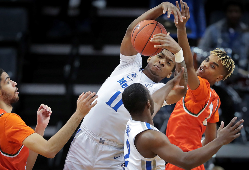 <strong>University of Memphis guard Antwann Jones (11) pulls down a rebound under pressure by Florida A&amp;M's MJ Randolph during the Tigers game against the Rattlers at the FedExForum on Dec. 29, 2018.</strong> (Jim Weber/Daily Memphian)