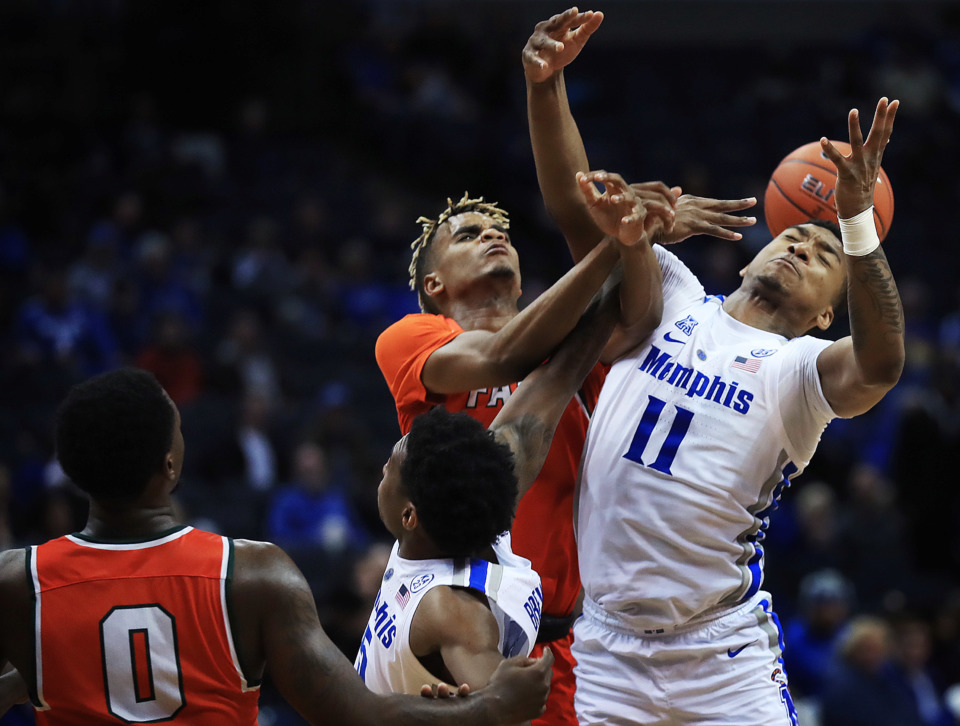 <strong>University of Memphis guard Antwann Jones (11) battles for a rebound with Florida A&amp;M's MJ Randolph during the Tigers game against the Rattlers at the FedExForum on Dec. 29, 2018.</strong> (Jim Weber/Daily Memphian)