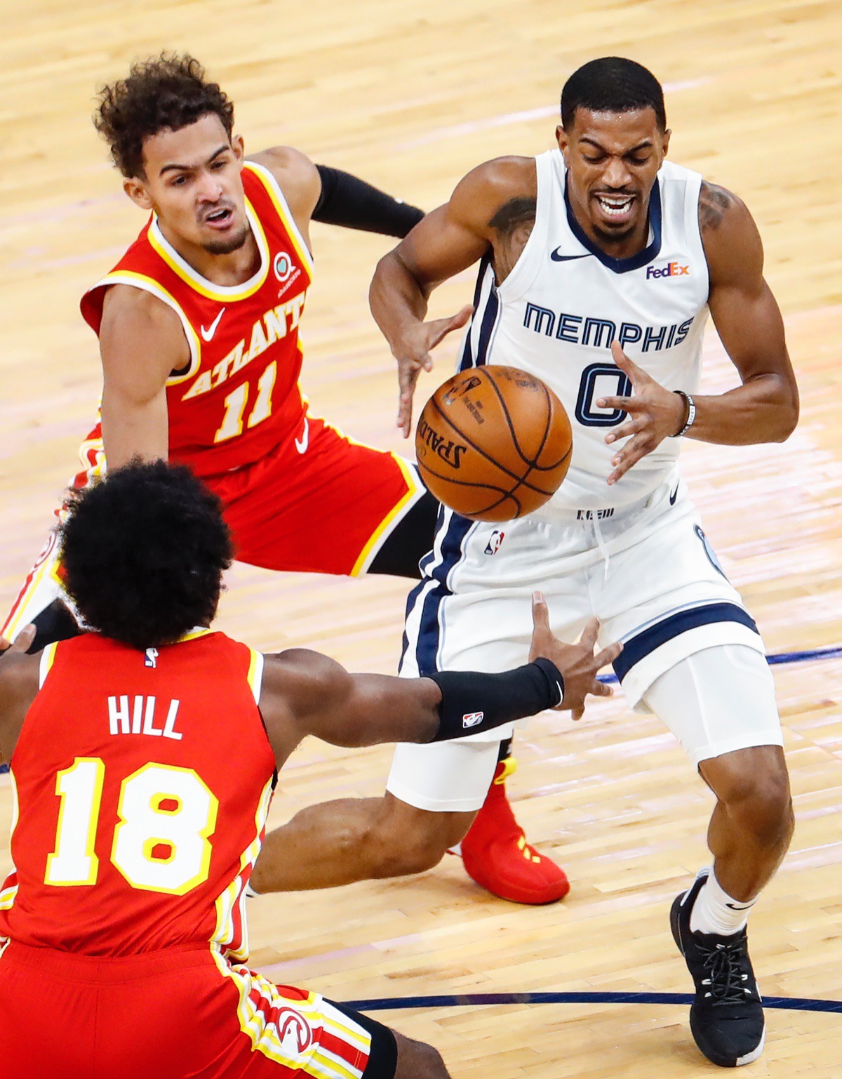 <strong>Memphis Grizzlies guard De'Anthony Melton (right) drives the lane against Atlanta&rsquo;s Trae Young (top) and Solomon Hill (bottom) on Thursday, Dec. 17, 2020.</strong> (Mark Weber/The Daily Memphian)