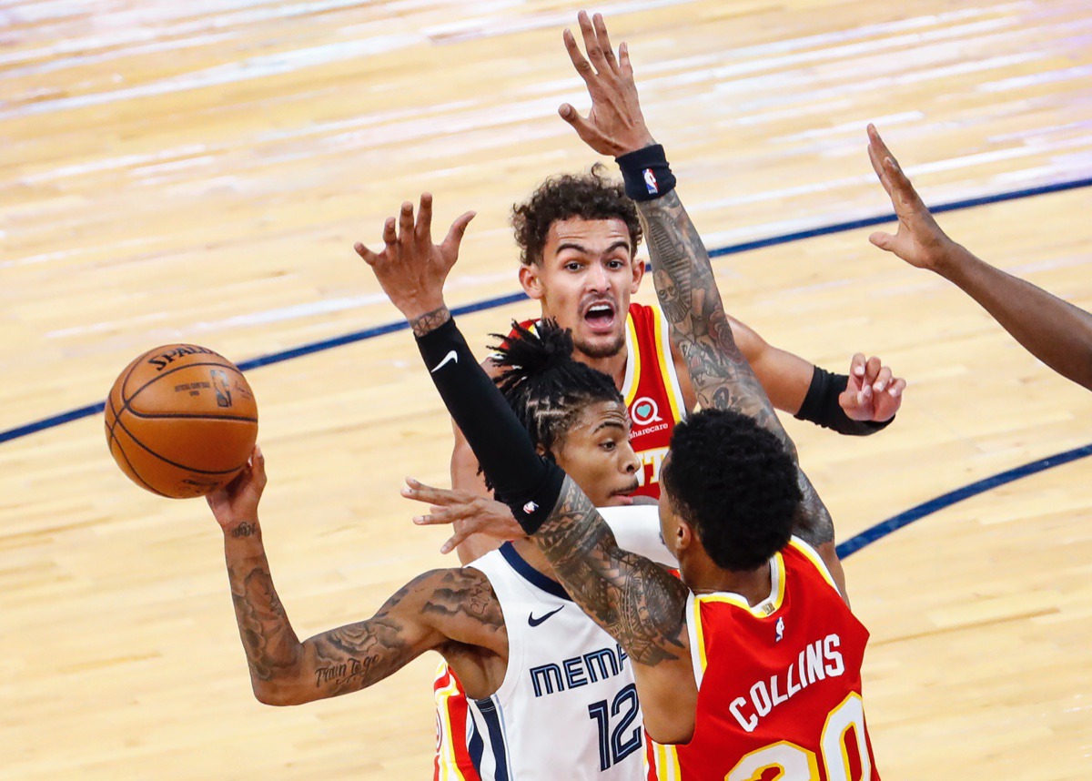 <strong>Memphis Grizzlies guard Ja Morant (middle) makes a pass while driving the lane against Atlanta&rsquo;s Trae Young (top) and John Collins (bottom) on Dec. 17, 2020.</strong> (Mark Weber/The Daily Memphian)