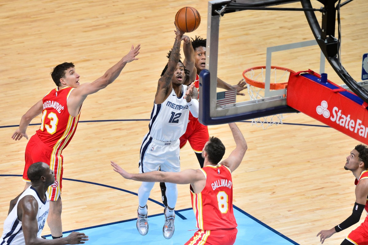 <strong>Memphis Grizzlies guard Ja Morant (12) shoots between Atlanta Hawks forward De'Andre Hunter, top, guard Bogdan Bogdanovic (13), and forward Danilo Gallinari (8) in the first half of an NBA preseason basketball game Saturday, Dec. 19, 2020, at FedExForum.</strong> (Brandon Dill/AP)