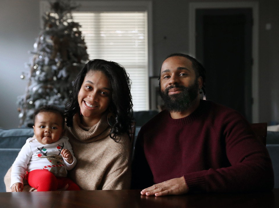 <strong>Leslie Berry (holding daughter Marlie), and Marlon Ross were thrilled to find a brand-new house, and the location is convenient to their jobs.</strong> (Patrick Lantrip/Daily Memphian)