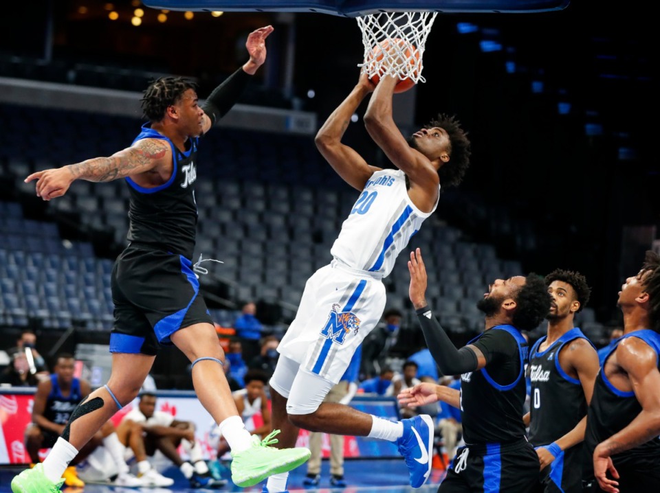 <strong>Memphis forward Ahmad Rand (middle) goes up for a lay-up against the Tulsa defense during action on Monday, Dec. 21, 2020.</strong> (Mark Weber/The Daily Memphian)
