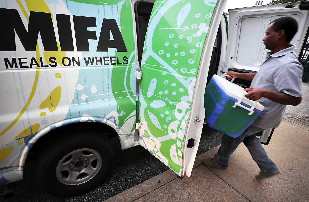 <strong>MIFA employee loads up meals for one of the organizations collection points on Thursday August 16, 2018. Fueled by thousands of volunteers, MIFA, which turns 50 this year, has gone high tech with pre-plotted routes and an app, but deliveries are still made with a personal touch. </strong>(Jim Weber/Daily Memphian)