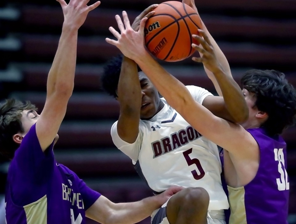 <strong>Collierville High School guard Danny Perry (5) tries to split a pair of Christian Brothers defenders on Tuesday, Dec. 22.</strong> (Patrick Lantrip/Daily Memphian)