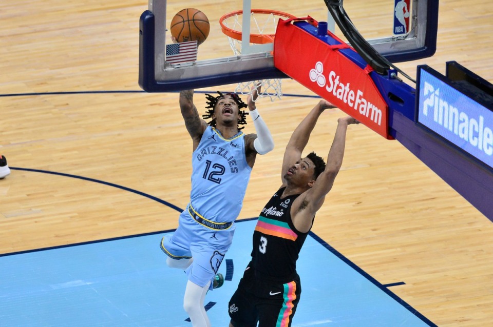 <strong>Memphis Grizzlies guard Ja Morant (12) shoots against San Antonio Spurs guard Keldon Johnson (3) in the second half of an NBA basketball game, Wednesday, Dec. 23, 2020, in Memphis, Tennessee.</strong> (AP Photo/Brandon Dill)