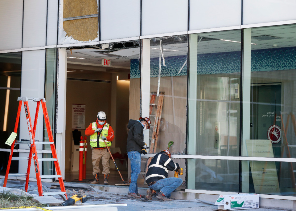 <strong>Workers secure an area near the main entrance at Methodist University Hospital Saturday, Dec. 26. A driver slammed into the wall off the circular drive on Bellevue Boulevard on Christmas night.</strong>&nbsp;(Mark Weber/Daiy Memphian)