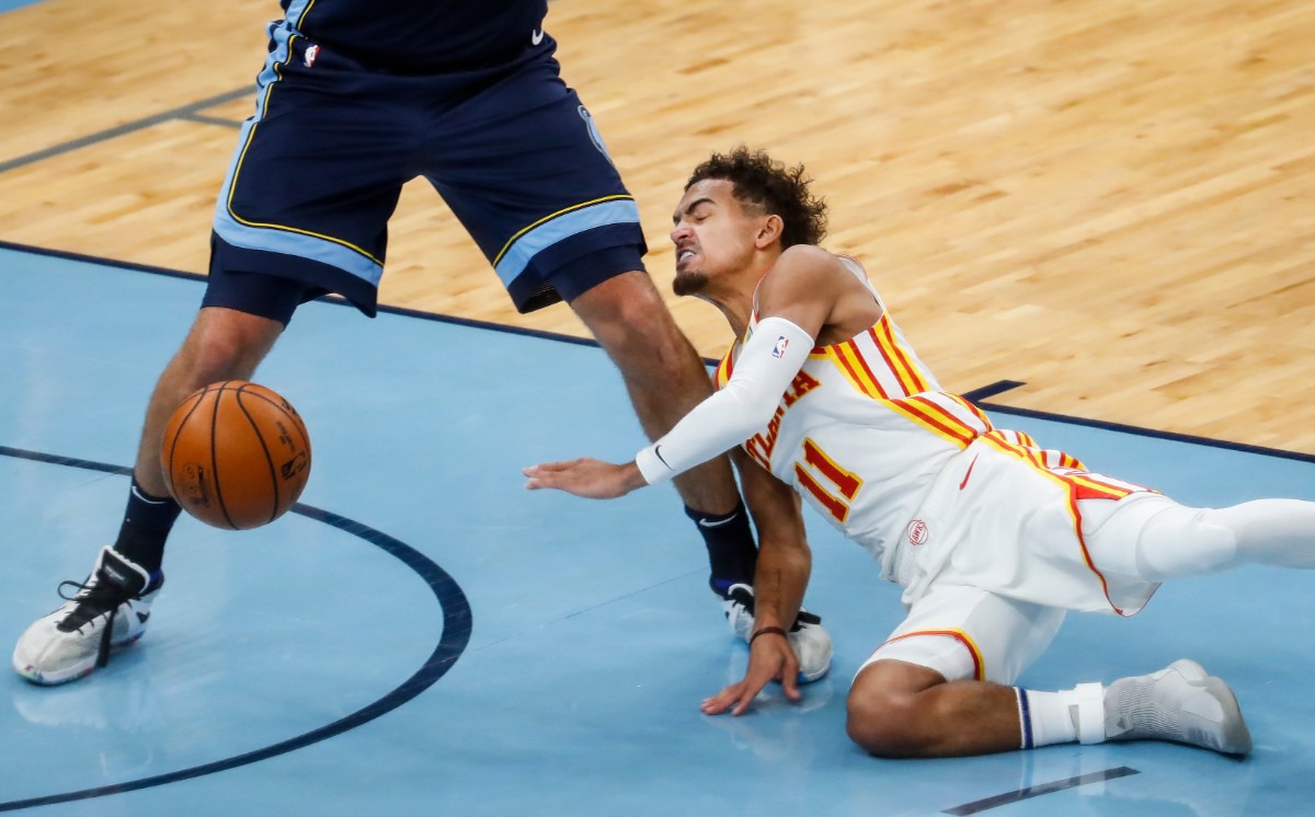 <strong>Atlanta Hawks guard Trae Young runs into the legs of Memphis Grizzlies defender Jonas Valanciunas after losing control of the ball during action on Saturday, Dec. 26, 2020.</strong> (Mark Weber/The Daily Memphian)