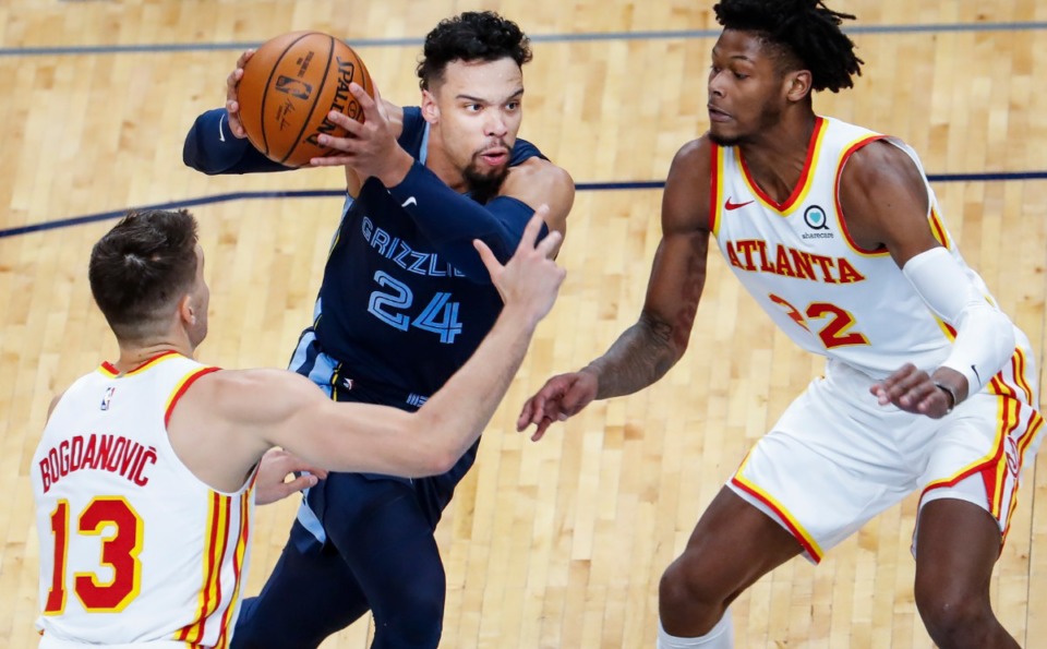 <strong>Memphis Grizzlies guard Dillon Brooks (middle) drives the lane against Atlanta Hawks defenders Bogdan Bogdanovic (left) and Cam Reddish (right) during action on Saturday, Dec. 26, 2020.</strong> (Mark Weber/The Daily Memphian)