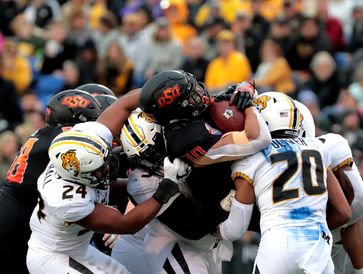 <strong>Oklahoma State running back Chubba Hubbard (30) gets tackled by a sea of Missouri defensive linemen during the AutoZone Liberty Bowl game on Dec. 31, 2018.</strong> (Houston Cofield/Daily Memphian)