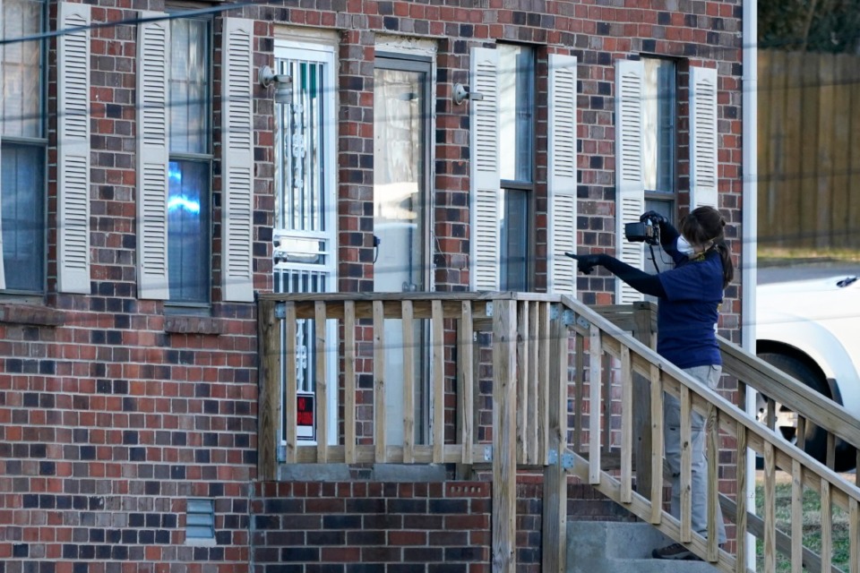 <strong>A member of the FBI Evidence Response Team photographs the entrance of a home Saturday, Dec. 26, 2020, in Nashville.</strong> (Mark Humphrey/AP)