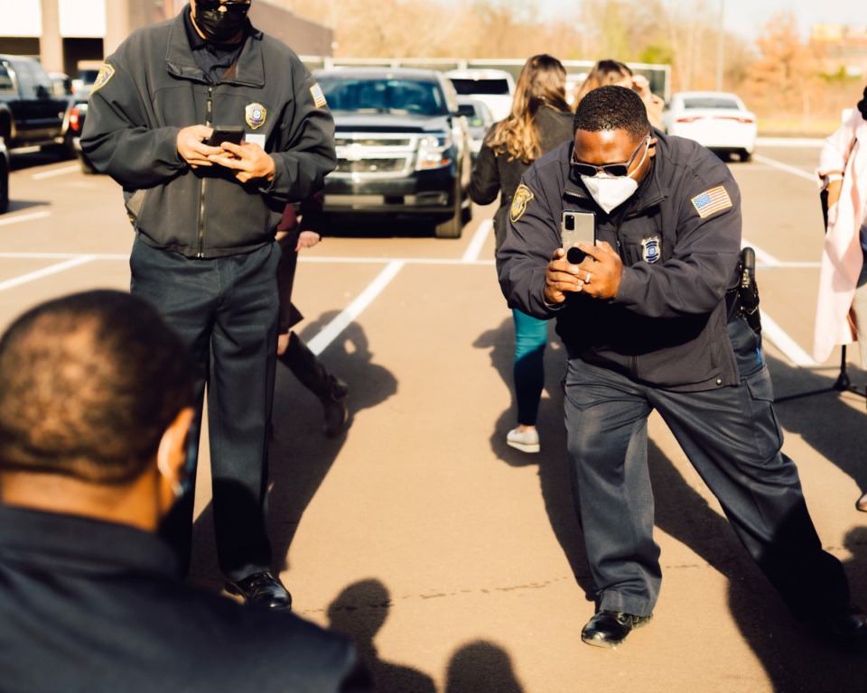 <strong>A Memphis Police officer takes a photo of a co-worker as he receives the coronavirus vaccination. Police officers, firefighters and EMTs in Shelby County got COVID-19 vaccines Monday, Dec. 28, in a drive-thru tent off Sycamore View Road and Summer Avenue.</strong> (Houston Cofield/Special to the Daily Memphian)