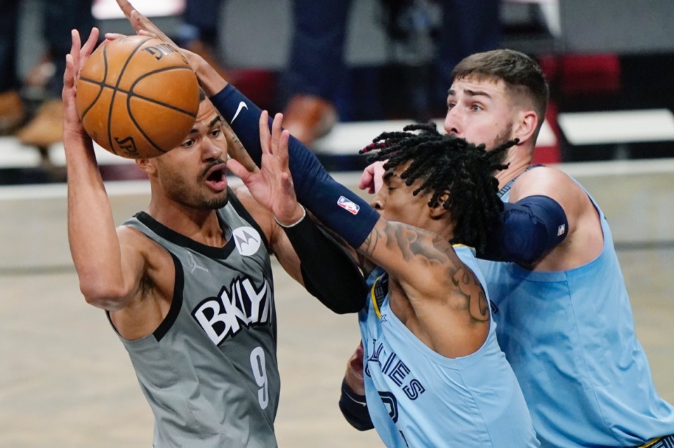 <strong>Brooklyn Nets guard Timothe Luwawu-Cabarrot (9) looks to pass the ball as Memphis Grizzlies guard Ja Morant (12) and center Jonas Valanciunas (17) attack on Monday, Dec. 28, 2020, in New York.</strong> (Kathy Willens/AP)