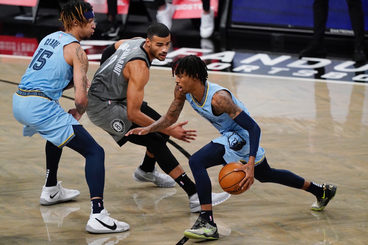 <strong>Grizzlies guard Ja Morant, right, drives past Brooklyn Nets guard Timothe Luwawu-Cabarrot (9) as forward Brandon Clarke (15) sets a screen on Monday, Dec. 28, 2020, in New York.</strong> (Kathy Willens/AP)