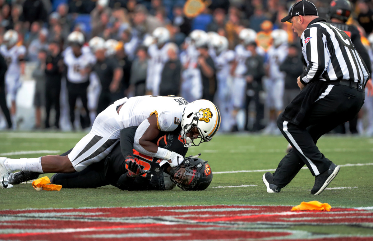 <strong>Missouri safety Ronnell Perkins (3) gets called for holding after pinning down Oklahoma State safety Za'Carrius Green in the AutoZone Liberty Bowl game on Dec. 31, 2018. Oklahoma State held off Mizzou to win 38-33.</strong> (Houston Cofield/Daily Memphian)