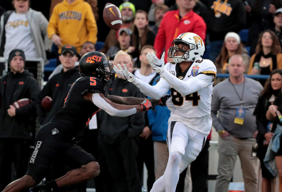 <strong>Missouri wide receiver Emmanuel Hall (84) reaches out to catch a pass while being guarded by Oklahoma State Cowboys defensive back Kemah Siverand (5) in the AutoZone Liberty Bowl game Dec. 31, 2018. Oklahoma State held off a fourth-quarter rally to beat Mizzou 38-33.</strong> (Houston Cofield/Daily Memphian)