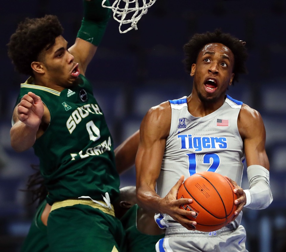 <strong>University of Memphis forward Deandre Williams (12) goes up for a contested layup against the University of South Florida on Dec. 29, 2020.</strong> (Patrick Lantrip/Daily Memphian)
