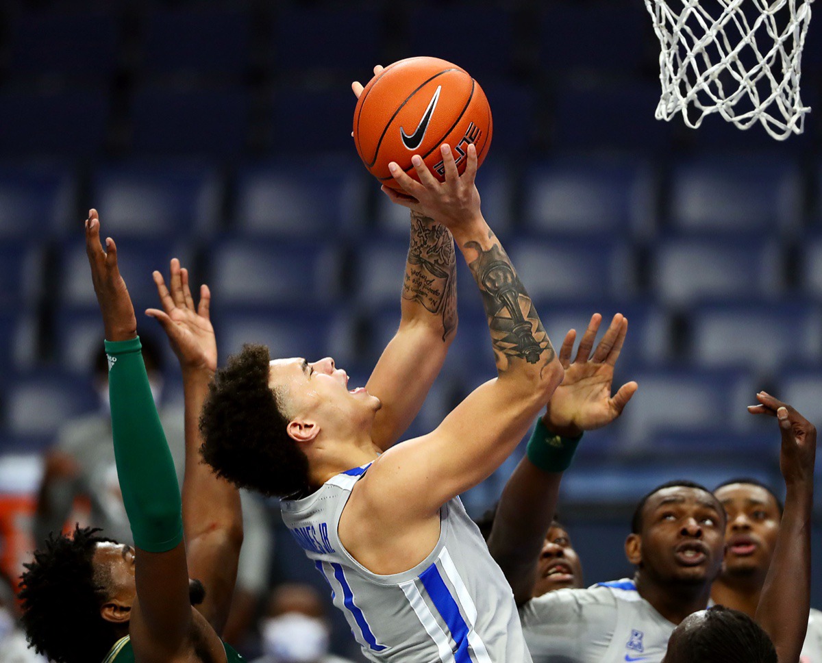 <strong>University of Memphis guard Lester Quinones (11) fights through a foul during a home game against the University of South Florida on Dec. 29, 2020.</strong> (Patrick Lantrip/Daily Memphian)