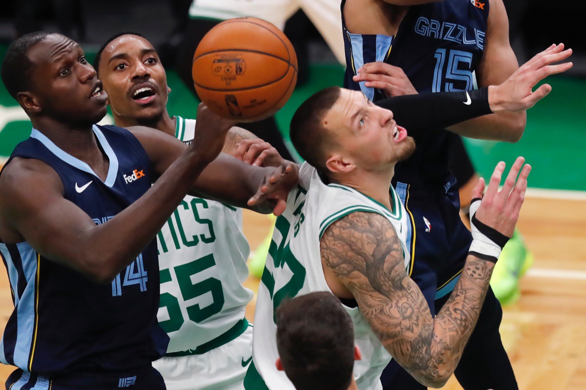 <strong>Memphis Grizzlies' Gorgui Dieng (14) battles for a rebound against&nbsp;Boston&rsquo;s Jeff Teague (55) and Daniel Theis (27) on Wednesday, Dec. 30, 2020, in Boston.</strong> (Michael Dwyer/AP)